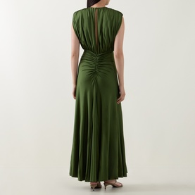 Model wearing Self-Portrait olive maxi dress, rear view showing ruched back detail, sleeveless cut and flared skirt in satin-finish fabric.
