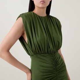 Model wearing Self-Portrait olive ruched sleeveless dress with gathered waist detail and crew neck, cropped view showing bodice.