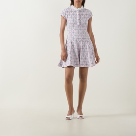 Model wearing Self-Portrait Pink Checked Knit Dress with ruffled collar and tiered skirt, styled with white mules