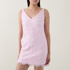 Model wearing Self-Portrait pink lace mini dress with V-neckline, sleeveless cut and scalloped hem detailing.