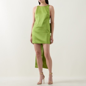 Model wearing Self-Portrait green sleeveless mini dress with asymmetric draped back detail, styled with nude strappy heeled sandals.