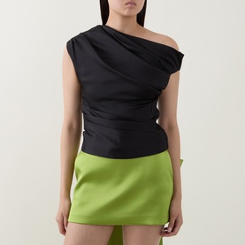 Model wearing Self-Portrait black one-shoulder draped top, styled with a lime green mini skirt.