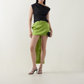 Model wearing Self-Portrait black one-shoulder top, styled with lime green belted mini skirt and black heeled sandals.