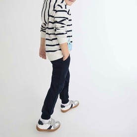 Model wearing Street Monkey Ecru 2 Piece set, navy stripe top and navy joggers, styled with silver trainers