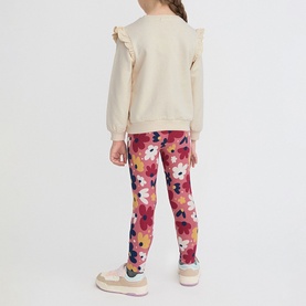 Model wearing Street Monkey ecru ruffle-shoulder sweatshirt with pink floral leggings and pink trainers, rear view