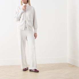 Model wearing Varley Ivory Marl sweat bottoms with matching zip-up top and burgundy trainers.