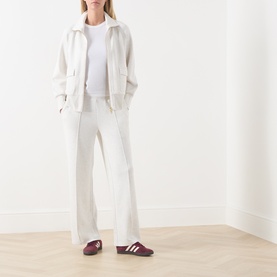 Model wearing Varley Ivory Marl Sweat Bottoms, styled with matching zip jacket, white tee and burgundy Adidas trainers.