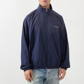 Model wearing Acne navy casual jacket with zip fastening, funnel neck, and small logo script detail on chest