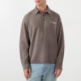 Model wearing Acne Logo Knitted Polo Sweater in brown melange with polo collar and embroidered logo, styled with light blue jeans.