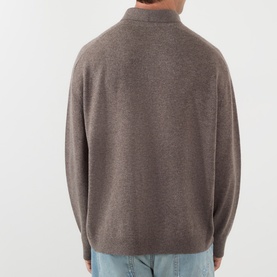 Model wearing Acne Logo Knitted Polo Sweater in brown melange wool, back view, with light blue jeans visible at hem.