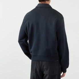 Model wearing Acne faded black cotton zip-collar sweatshirt, rear view, styled with dark jeans