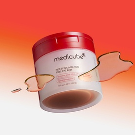 Medicube Red Succinic Acid Peeling Pads in red and white tub with peeling pad and liquid splash detail