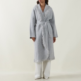 Model wearing Odd Muse grey wool belted coat with fringe trim detailing, styled with white wide-leg trousers