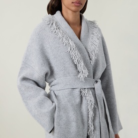 Model wearing Odd Muse grey wool belted cardigan coat with fringe trim detail along lapels and belt tie waist.