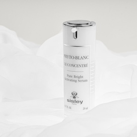 Sisley Phyto-Blanc Pur Concentr&eacute; Pure Bright Activating Serum in white pump bottle, 30ml, on soft white fabric backdrop