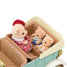 Sylvanian Families bear figures seated in a cream vintage car, dressed in red plaid, blue and white outfits, multicoloured set