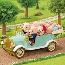 Sylvanian Families vintage-style mint green toy car with gold detailing, filled with multiple pig family figures, set in outdoor scene.