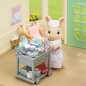 Sylvanian Families nurse rabbit figure in white uniform with grey medical trolley, accessories and pastel room setting