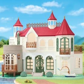 Sylvanian Families grand castle dollhouse with red turret roofs, white fa&ccedil;ade, green arched windows, balconies, and waterside setting