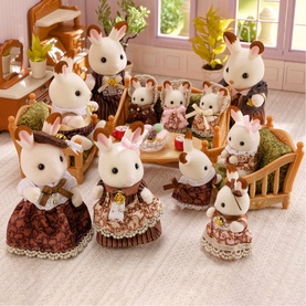 Sylvanian Families chocolate rabbit family playset with multiple figures in brown and cream outfits, styled in a miniature home setting with
