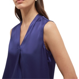 Model wearing Hobbs violet blue sleeveless satin blouse with V-neckline and collar detail