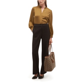 Model wearing Hobbs khaki green long-sleeve blouse with black wide-leg trousers and loafers, carrying a monogram tote bag
