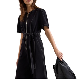 Model wearing Phase Eight black zip-front midi dress with contrast stitching and tie belt, styled with a black leather jacket
