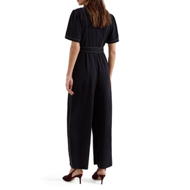 Model wearing Phase Eight black short-sleeve wide-leg jumpsuit with contrast stitching detail, styled with burgundy heels, back view