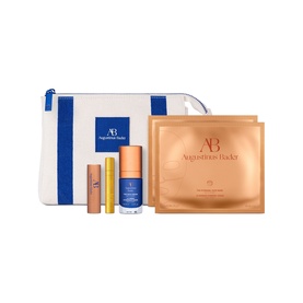 Augustinus Bader Skincare Set with white and blue zip pouch, mini serum, lip treatment, and two gold sheet masks