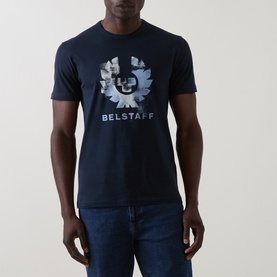 Model wearing Belstaff Crew Neck T in Dark Ink, featuring large camo-style logo graphic print, styled with dark blue jeans.