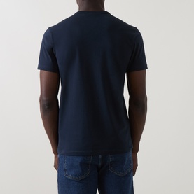 Model wearing Belstaff Crew Neck T in Dark Ink, rear view, styled with blue denim jeans.