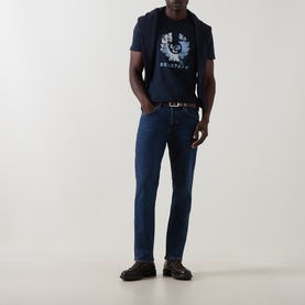 Model wearing Belstaff Dark Ink crew neck T-shirt with graphic print, styled with dark wash jeans and brown leather belt.