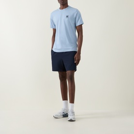 Model wearing Belstaff Phoenix Logo T-Shirt in Mist Blue with navy shorts and white trainers.