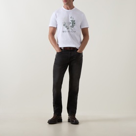 Model wearing Belstaff Blur Logo T-Shirt in white with graphic print, styled with black jeans and black leather shoes.