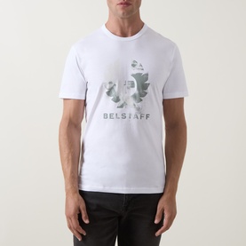 Model wearing Belstaff Blur Logo T-Shirt in white, featuring tonal camo-style logo graphic, crew neck, short sleeves, styled with dark trousers.