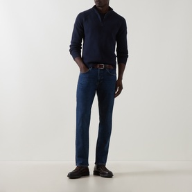 Model wearing Belstaff Dark Ink cotton half zip jumper, styled with dark wash jeans, brown belt and black loafers.