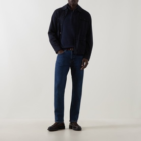 Model wearing Belstaff Dark Ink cotton half zip, styled with navy harrington jacket, dark wash jeans and black loafers.