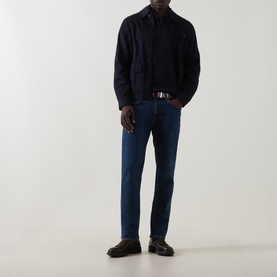 Model wearing Belstaff 3049 Straight Jeans in Washed Indigo, styled with a navy overshirt, belt, and dark loafers.