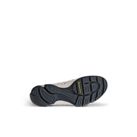 Shoe sole view showing dark grey rubber outsole with chunky tread pattern and yellow brand logo label