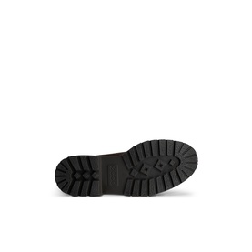 Black chunky rubber lug sole with deep treaded grip pattern, shown from beneath