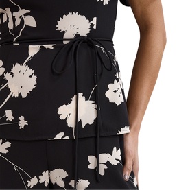 Model wearing Phase Eight black ivory floral tiered midi dress with tie waist detail, shown from waist to hem.
