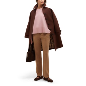 Model wearing Hobbs sweet pink knit top styled with brown coat, camel trousers and brown loafers