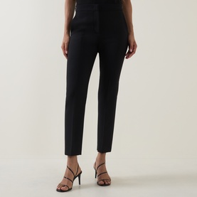 Model wearing Max Mara Main Acino Straight-Leg Trousers in black, slim mid-rise fit with pressed creases, styled with strappy heeled sandals
