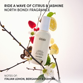 Ouai North Bondi Leave-In Conditioner bottle surrounded by lemon slices, raspberries and white jasmine flowers