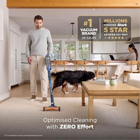 Shark PowerDetect Speed Clean and Empty Pet Pro Cordless Vacuum in blue, used by man in living room with dog, text reads Optimised Cleaning with Zero