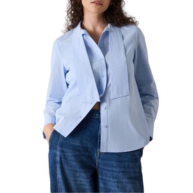 Model wearing Whistles blue oversized cotton shirt with contrast panel detail, styled with wide-leg denim jeans