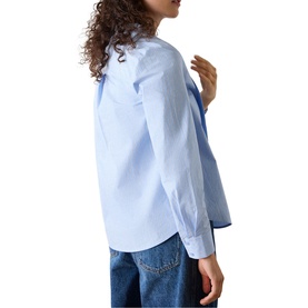 Model wearing Whistles blue long-sleeve shirt, rear view, styled with blue denim jeans