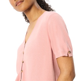 Model wearing Whistles pink short-sleeve top with V-neck and gold button detail at cuffs and front placket.