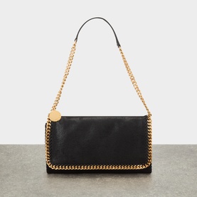 Stella McCartney Falabella black crossbody bag with gold-tone chain trim, coin charm, and adjustable chain shoulder strap