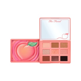 Too Faced Sweet Peach Eye Shadow Palette, open compact showing nine warm peachy-pink and bronze shades with peach artwork lid